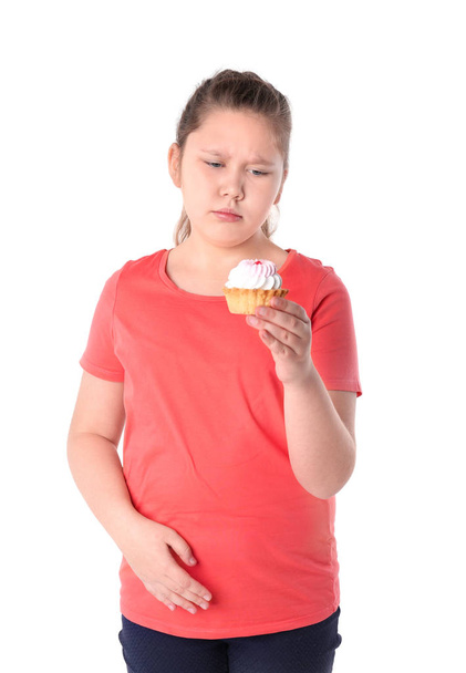 Overweight girl with cake on white background - Foto, imagen