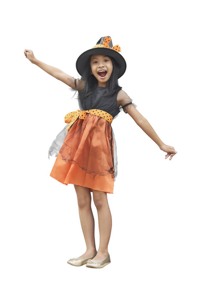 Happy asian girl in witch costume and hat standing isolated over white background - 写真・画像