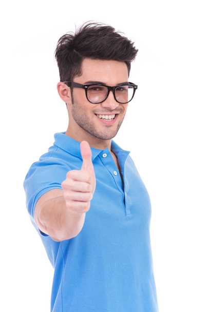 young casual man making the ok thumbs up hand sign on white background - Фото, изображение