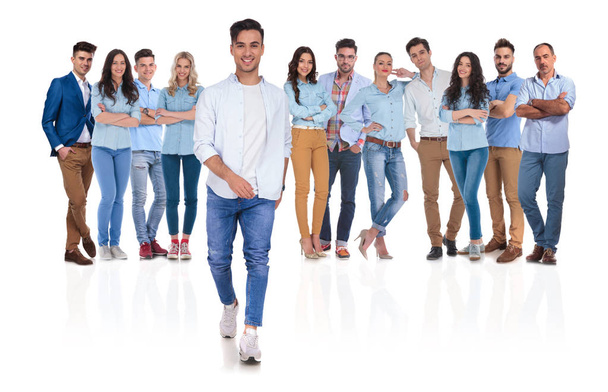 happy casual group leader stepping in front of his team on white background - Photo, Image