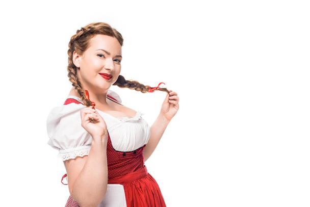 smiling oktoberfest waitress in traditional bavarian dress with pigtails isolated on white background - Foto, Imagen