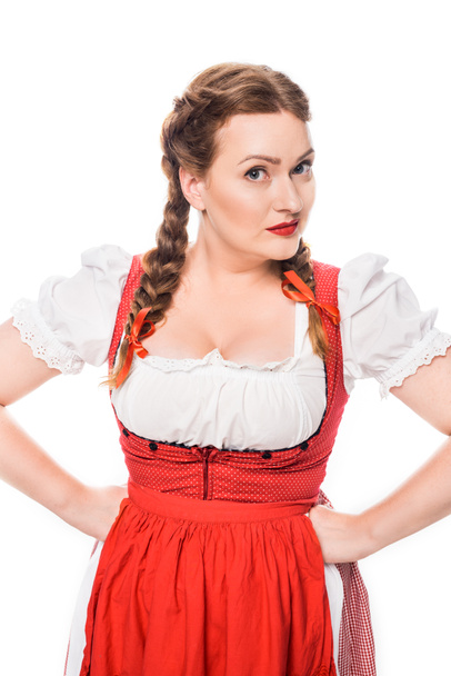beautiful oktoberfest waitress in traditional bavarian dress standing with hands on waist isolated on white background - 写真・画像