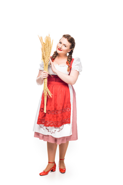 attractive oktoberfest waitress in traditional bavarian dress holding wheat isolated on white background - Fotografie, Obrázek