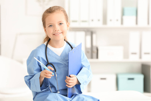 Cute little girl in doctor uniform  - Zdjęcie, obraz