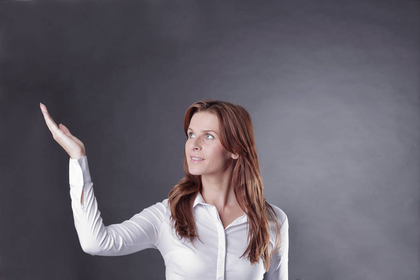 business woman pointing on copy space.isolated on dark - Photo, image