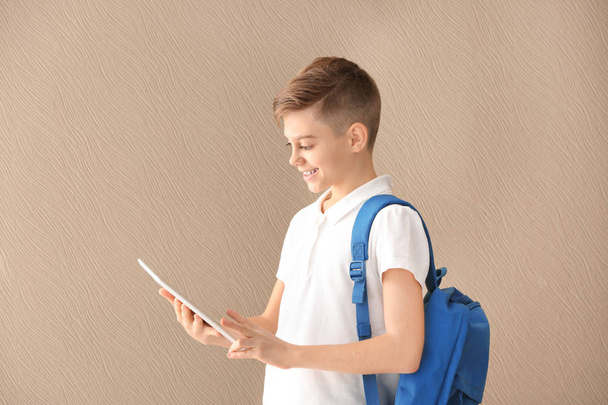 Portrait of teenager with tablet computer on color background - Fotoğraf, Görsel