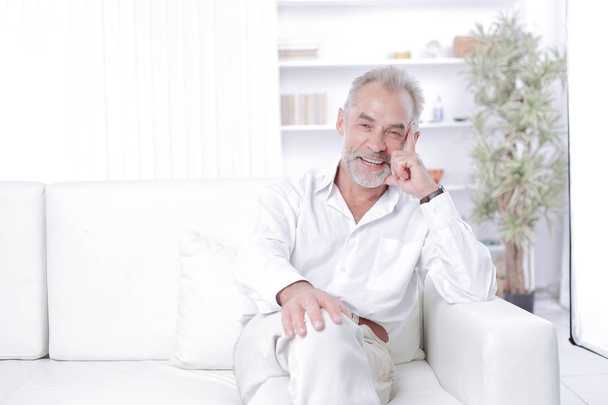 веселий старший бізнесмен сидить на дивані в офісі
 - Фото, зображення