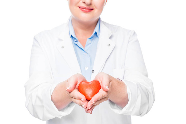 cropped image of female doctor in white coat showing heart symbol isolated on white background - Fotó, kép