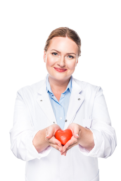 smiling female doctor in white coat showing heart symbol isolated on white background - Photo, image