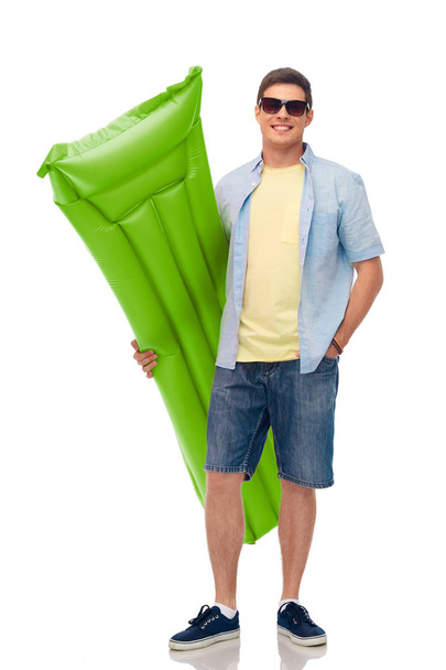 man in sunglasses with inflatable pool mattress - Zdjęcie, obraz