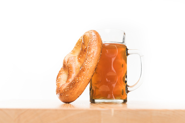 selective focus of pretzel and beer on wooden table on white background  - Fotografie, Obrázek