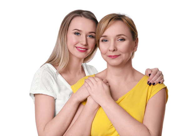 Young woman with her mother on light background - Photo, image