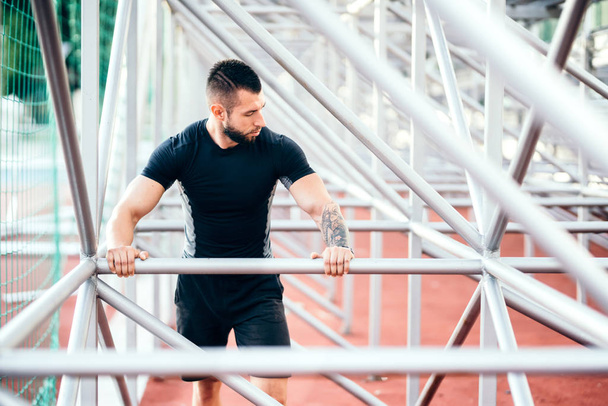 Fitness training outdoors. Portrait of bearded man working out - Fotografie, Obrázek