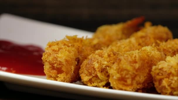 Deep fried prawns coated with crispy flour in white plate over wooden background - Footage, Video