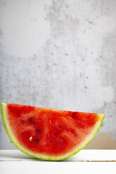 Piece of watermelon on a wooden table. Delicious dessert. - Foto, Imagem