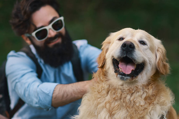 Σκυλί και τον ιδιοκτήτη - Cool σκυλί και νεαρός άνδρας που έχει τη διασκέδαση - Φωτογραφία, εικόνα
