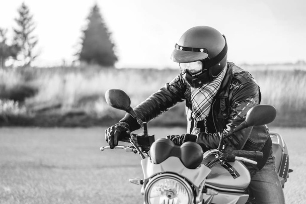 Biker riding on sport motorcycle outdoor on road - 写真・画像