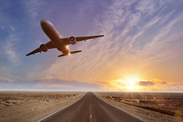 Road with taking off airplane. Travel and vacation concept - Photo, Image
