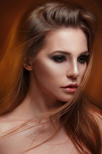 Mysterious beauty portrait of a chic woman with long straight hair, mixed light. - Foto, Bild