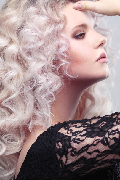 Fashion beauty portrait of a fragile girl gorgeous blonde with a cloud of small curls in pastel colors - Photo, Image
