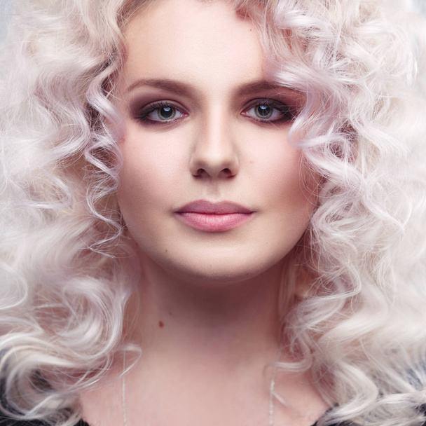Fashion beauty portrait of a fragile girl gorgeous blonde with a cloud of small curls in pastel colors - Фото, изображение