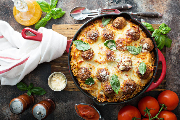 Baked meatballs with spaghetti, tomato sauce, basil and cheese overhead view - Photo, image