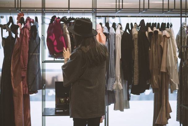 Girl in a clothing store - shopping concept - Photo, Image