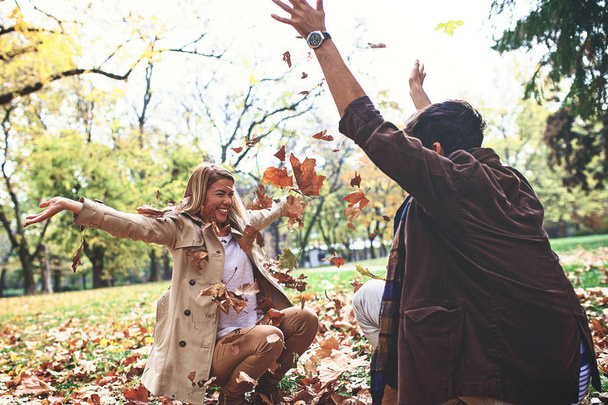 Young couple is enjoying fall in the park. - Valokuva, kuva