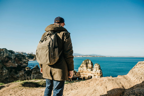 Tourist or traveler with a backpack on the Atlantic coast. - Zdjęcie, obraz
