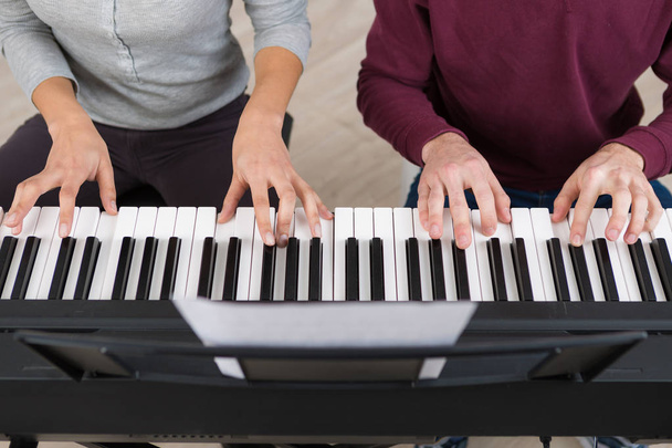twee personen spelen de toetsenborden - Foto, afbeelding