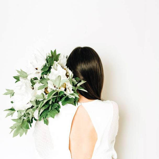 Young woman holding white peonies bouquet on white background. - Foto, Imagem