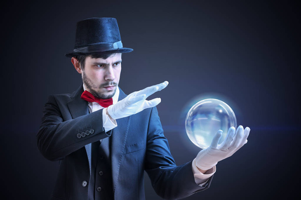 Young illusionist is predicting future and fortune telling from magical ball. - Photo, Image