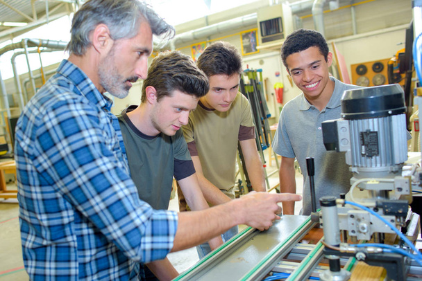 engineers and apprentices with cnc machine - Photo, image
