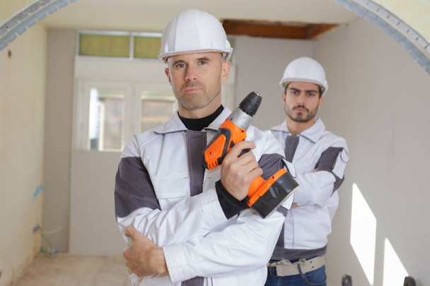 builder with drill and man - Zdjęcie, obraz