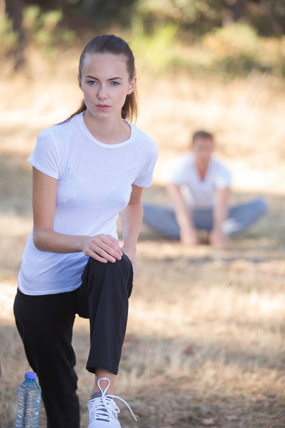 young woman stretching before a run outdoors - Photo, Image
