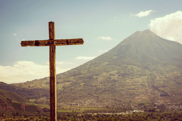 Large cross stands in front of a volcano in Antigua, Guatemala - Photo, Image