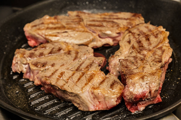 Three Chuck Steaks Turned on Grill - Photo, Image