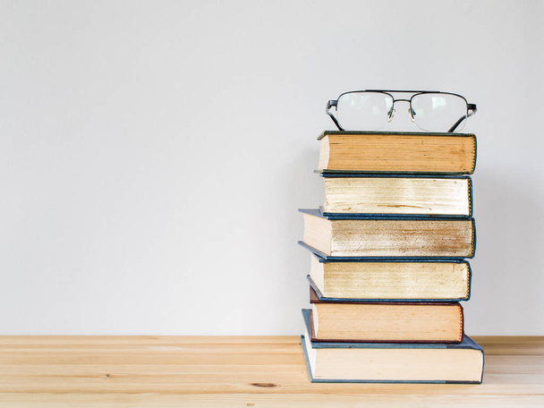 A lot of books for studying and black glasses - 写真・画像