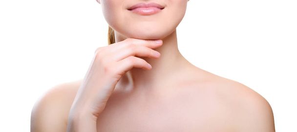 Portrait of girl with nude make-up with hands on chin isolated on white background. Girl with clean healthy skin on white. Cosmetology, medicine, beauty care. Nude makeup - 写真・画像
