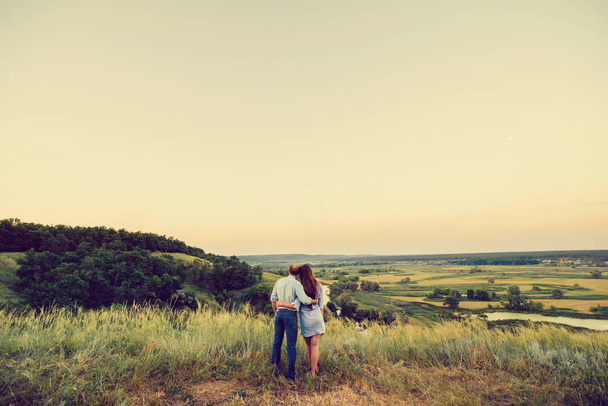 Couple in love is hugging on a hill. Free space - Foto, afbeelding