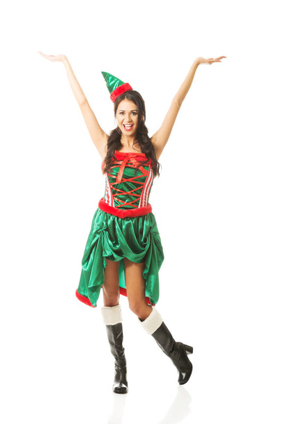 Full length woman with hands up wearing elf clothes - Фото, изображение
