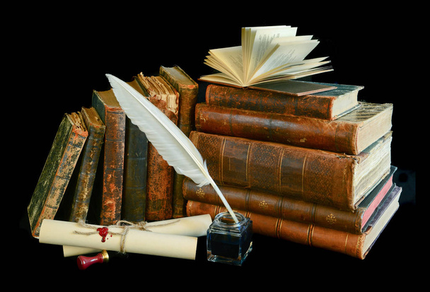 Still life with a letter, a pen and old books isolated on a black background - Photo, Image