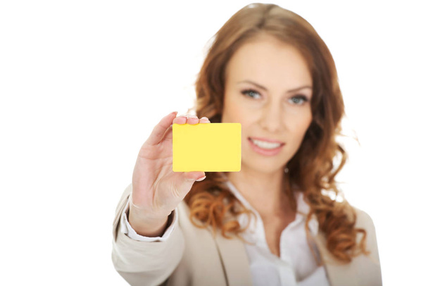Businesswoman holding blank card. - Photo, image