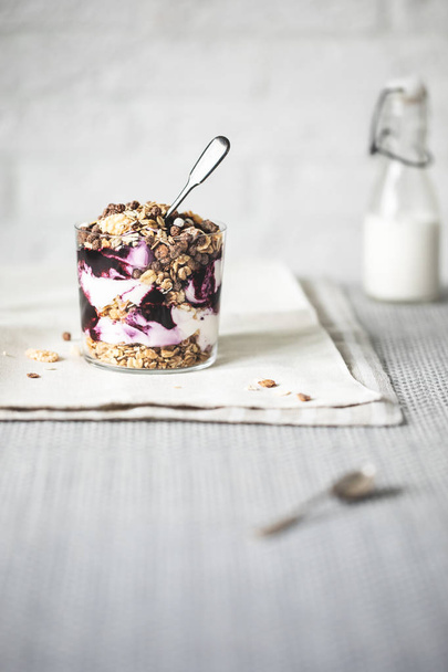 delicious granola in glass with spoon on table  - Photo, Image
