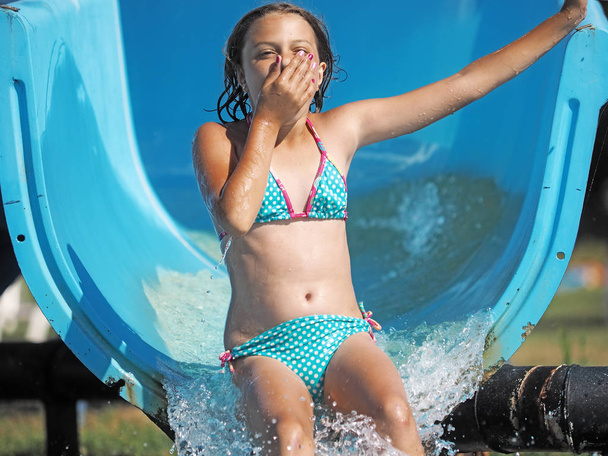 Little girl playing in a water park - Photo, Image