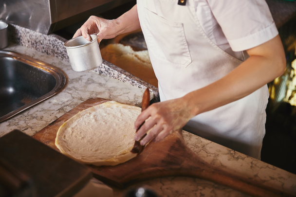 Oříznout záběr šéfkuchař připravující pizzu v restauraci kitchen - Fotografie, Obrázek