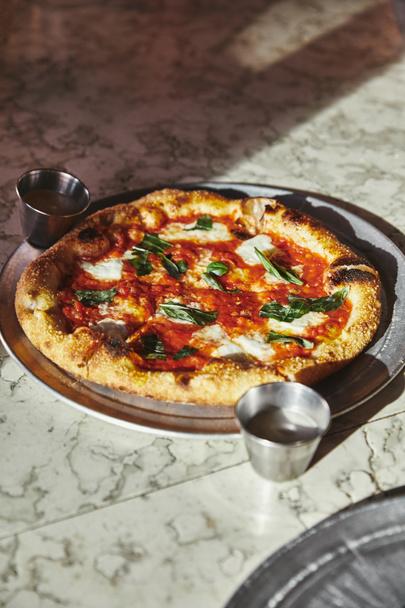 close-up shot of delicious pizza margherita on marble tabletop - Photo, Image