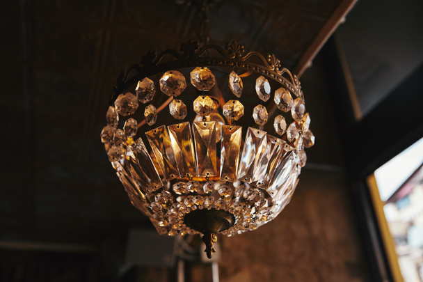 close-up shot of vintage chandelier hanging from ceiling of restaurant - Photo, Image