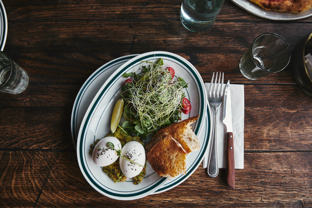 top view of healthy salad with sprouts and eggs on rustic wooden table - 写真・画像