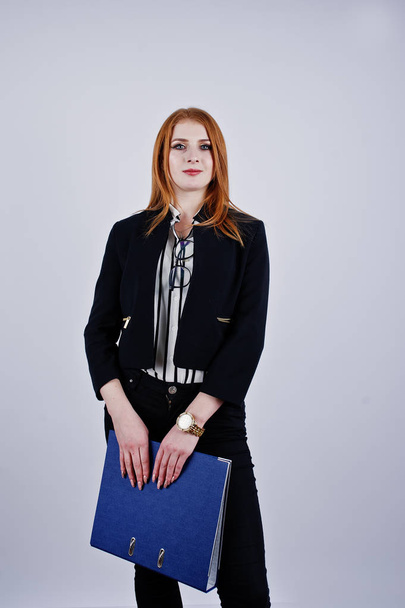 Portrait of a redheaded businesswoman wearing striped blouse and a jacket with a blue folder. - Фото, зображення